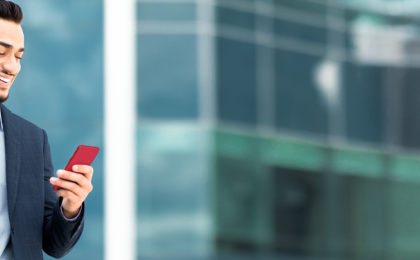 a man stood on his phone, looking at his upcoming interviews through People Firsts recruitment software.